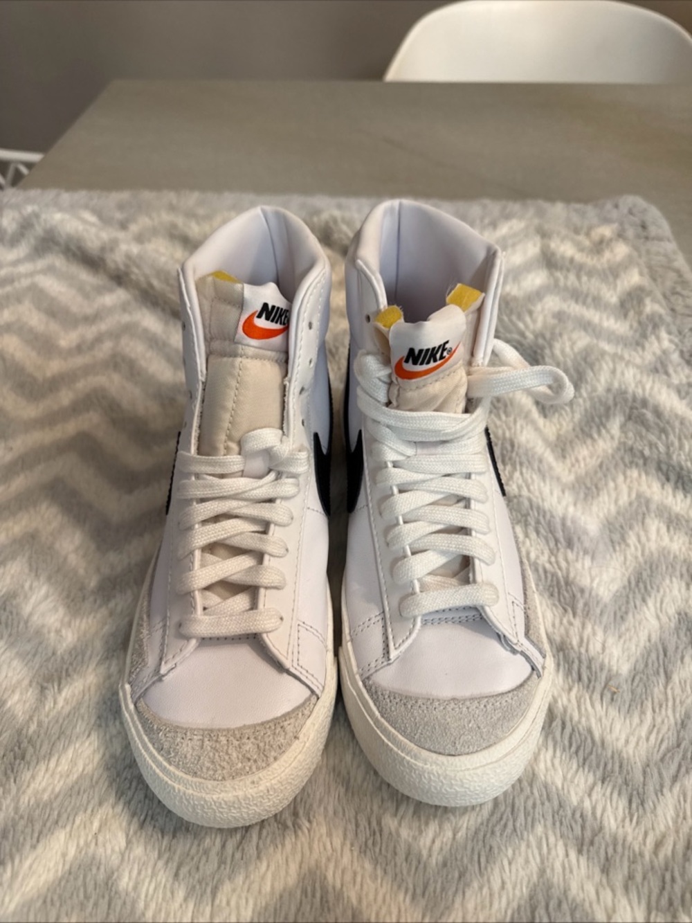 Nike White High-Top Sneakers with Black Swoosh and Orange Tongue Accent